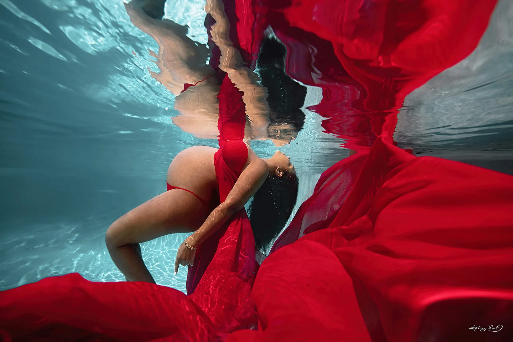 Underwater maternity photo session experience by Stephany Ficut Photography in red gown